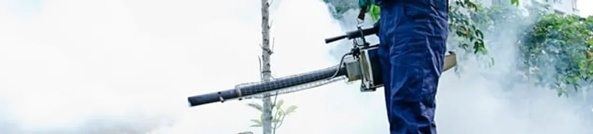 Pest control technician fogging an outdoor area for insect control in Akron, OH